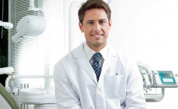Happy Male Dentist In Clinic